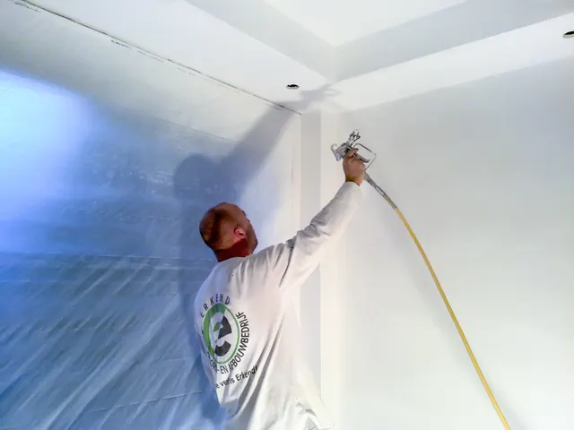 Airless spuiten van een plafond bij een afgeplakt raam